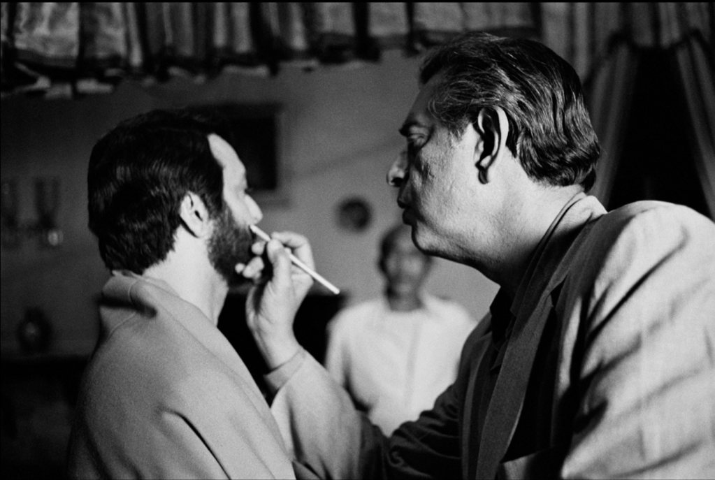 Fixing Soumitra Chatterjee’s makeup on the set of Ghare Baire (aka The Home and the World, 1984). Photo credit: Nemai Ghosh.